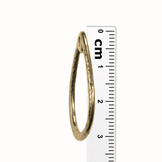 TierraCast Stitch-around Teardrop Charm / plated pewter with a bright gold finish / side view with ruler