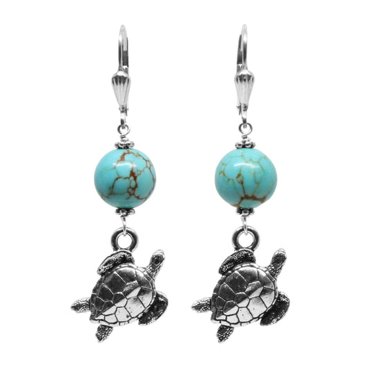 A pair of sea turtle earrings with turquoise and silver pewter charms, on sterling silver shell leverback earwires.