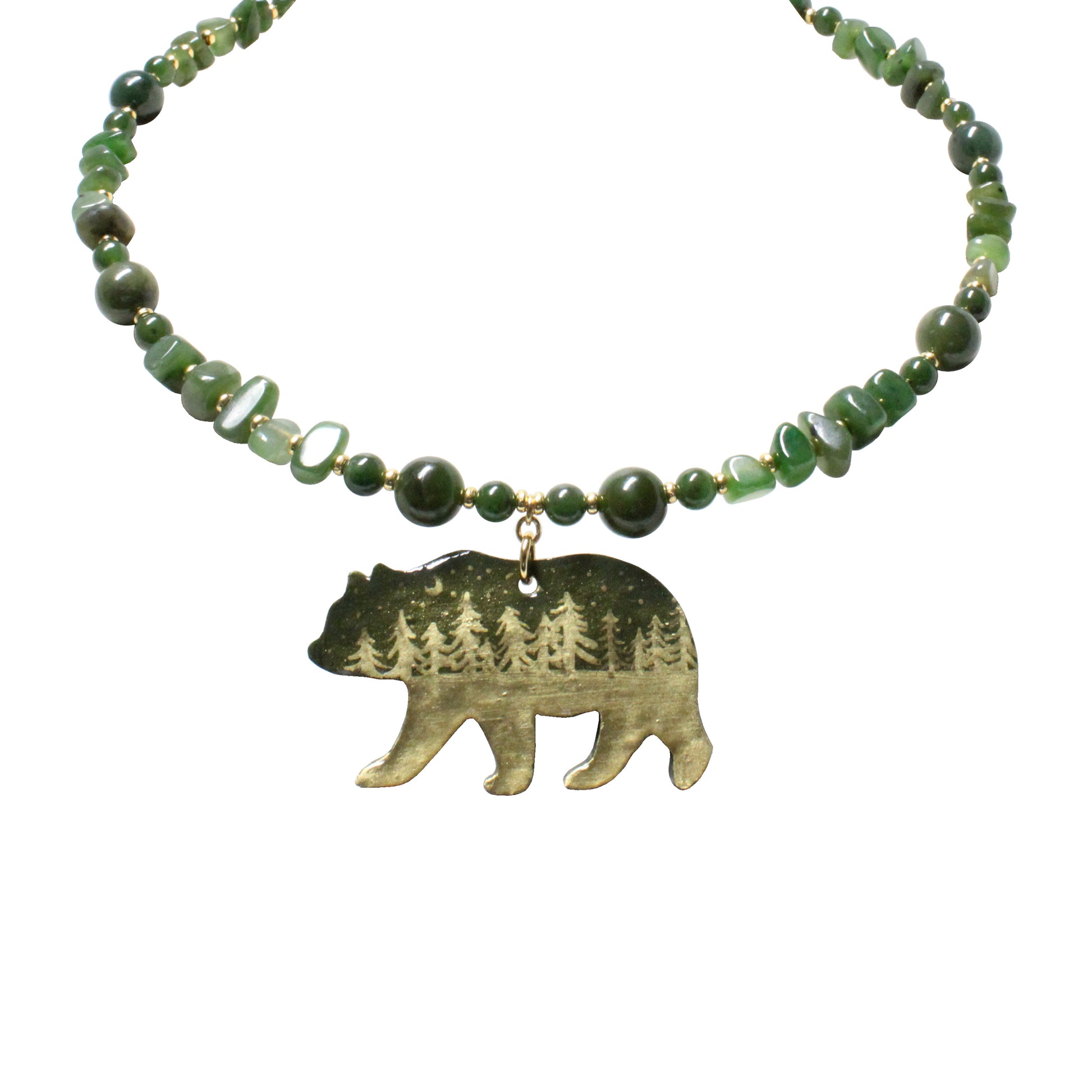 Close-up of hand-painted bear pendant with night forest scene and twinkling stars