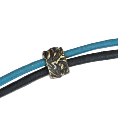 TierraCast Jardin Barrel Bead / pewter with a brass oxide finish - threaded on 2mm leather cords